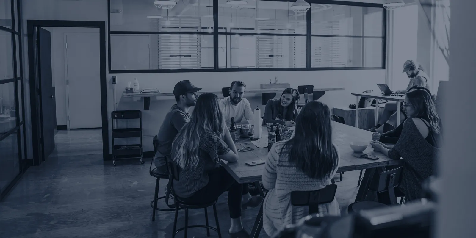 A team working together around one shared table in an open office